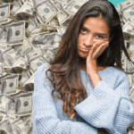 Woman looking stressed surrounded by cash